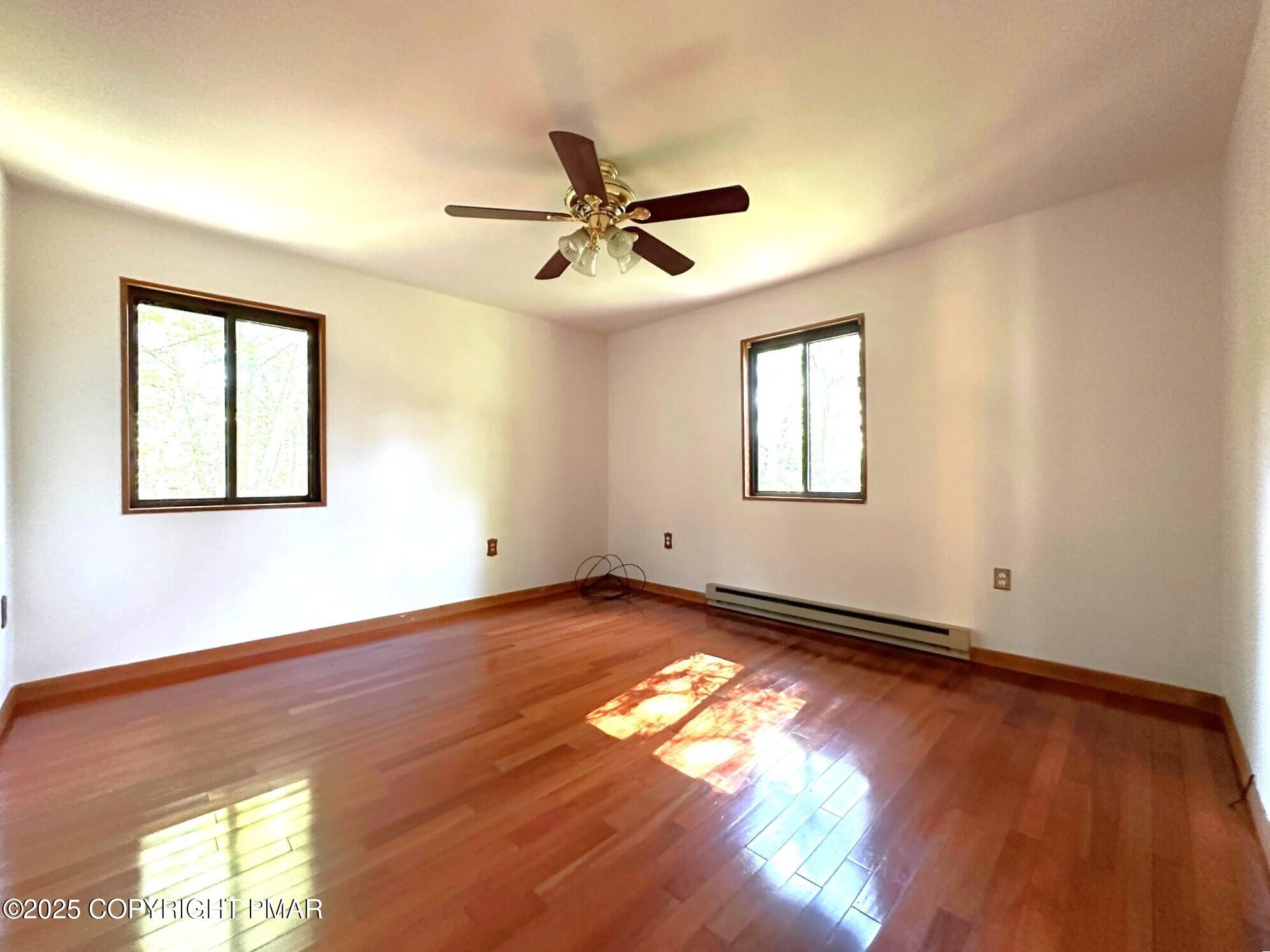 344 Pocono Boulevard, Unit 344 Bushkill, PA 18324 - Photo 11 of 20 a view of empty room with wooden floor and fan