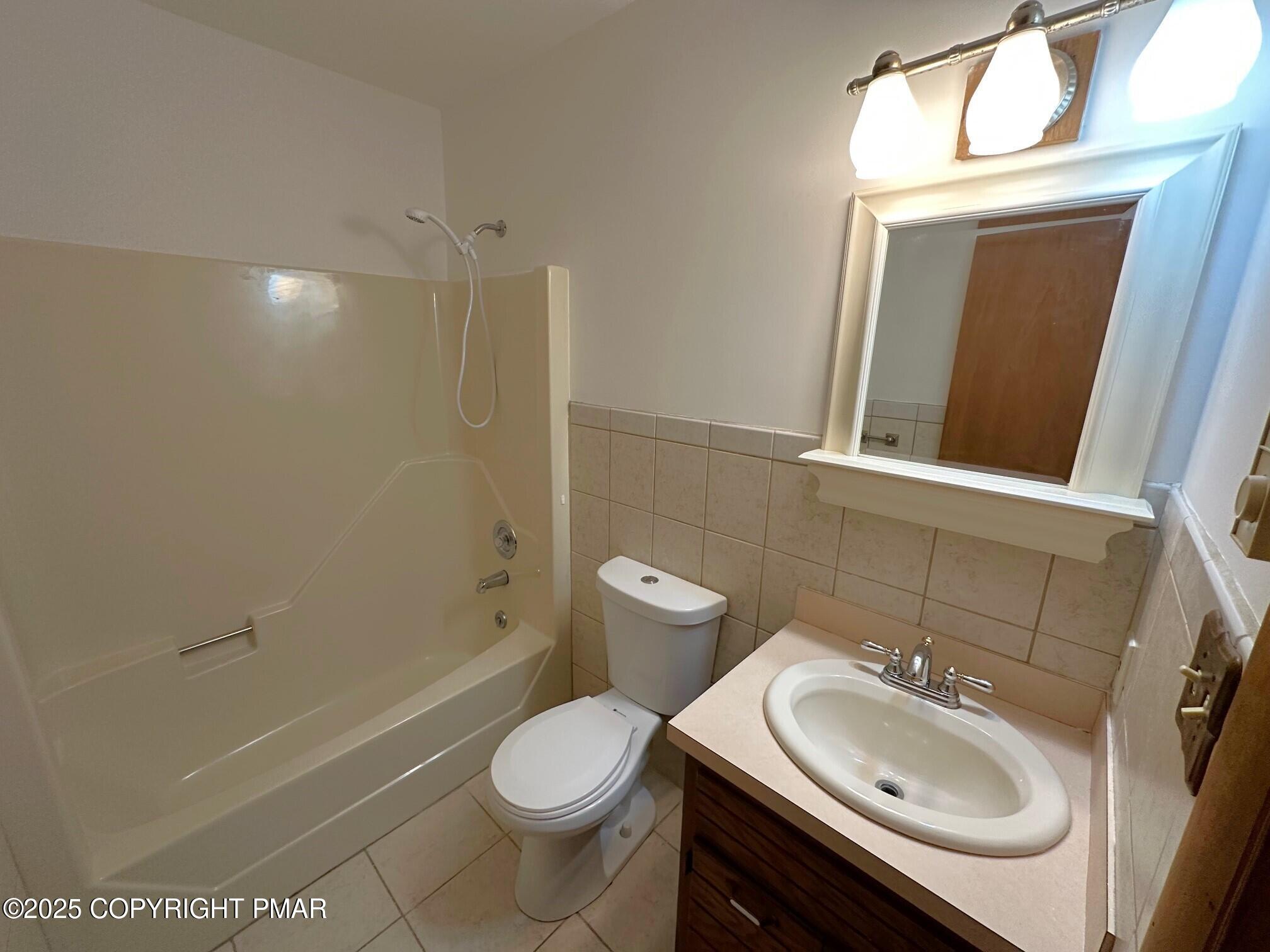 344 Pocono Boulevard, Unit 344 Bushkill, PA 18324 - Photo 15 of 20 a bathroom with a sink a toilet and shower
