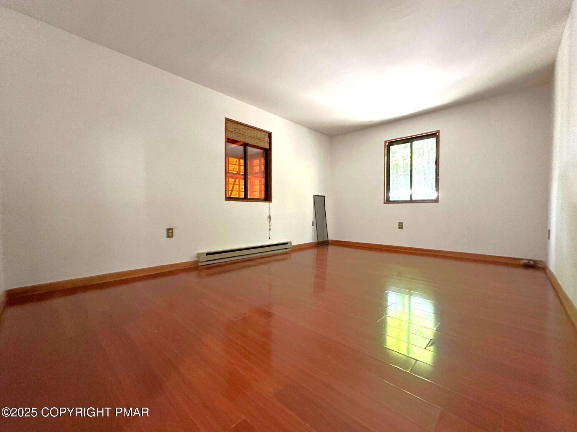 344 Pocono Boulevard, Unit 344 Bushkill, PA 18324 - Photo 18 of 20 a view of an empty room with window and wooden floor
