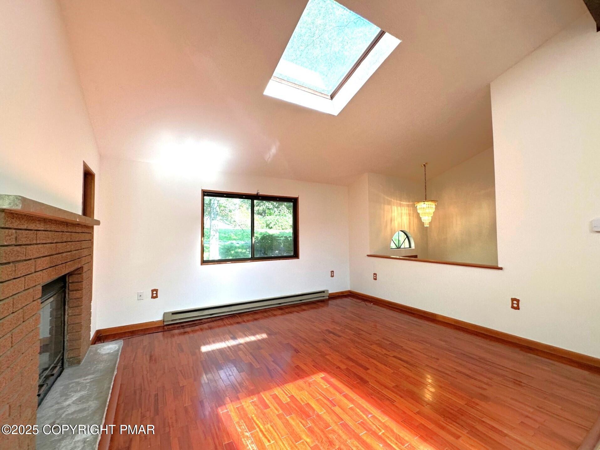 344 Pocono Boulevard, Unit 344 Bushkill, PA 18324 - Photo 4 of 20 a view of an empty room with window and wooden floor