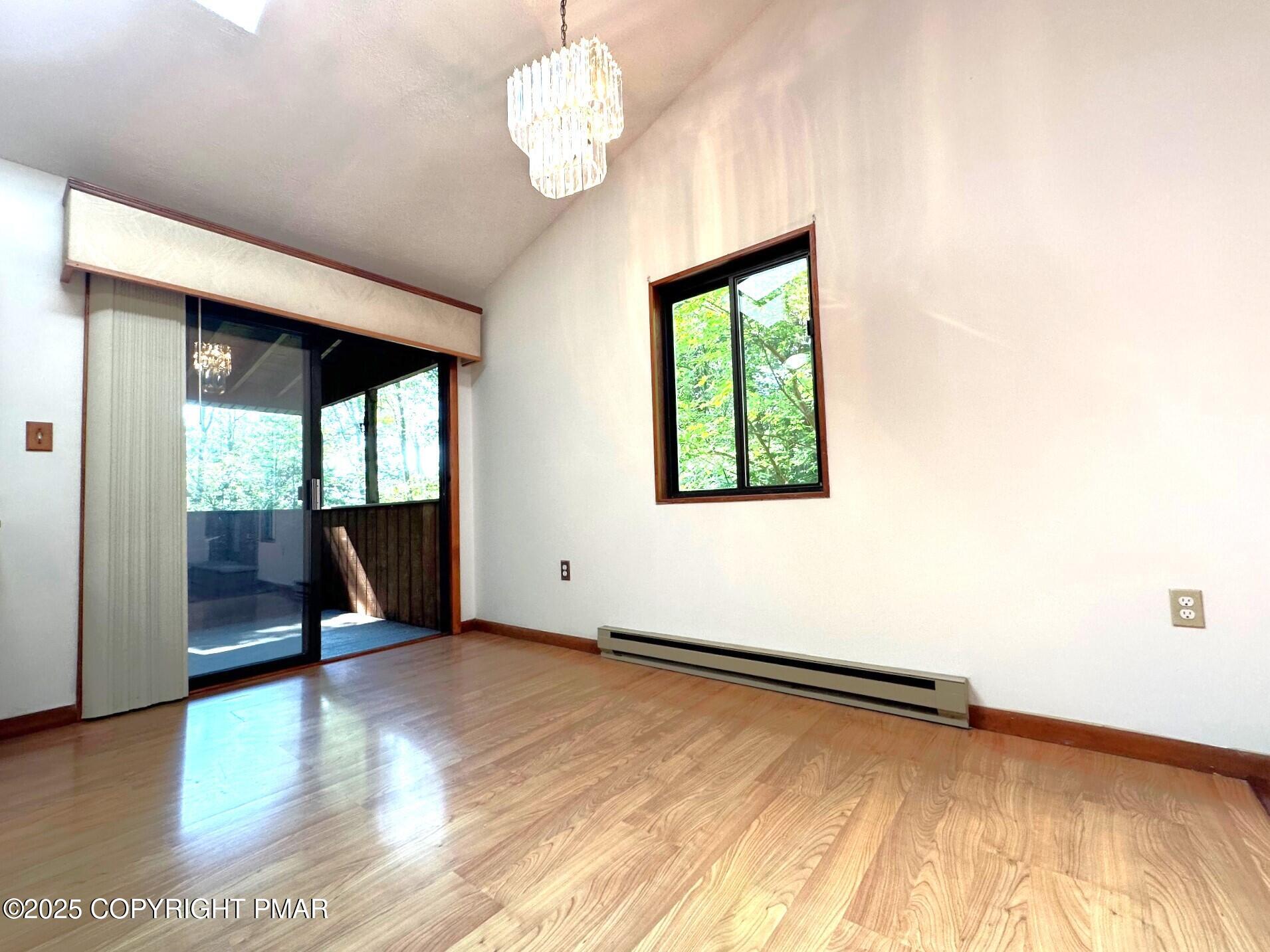 344 Pocono Boulevard, Unit 344 Bushkill, PA 18324 - Photo 5 of 20 a view of an empty room with wooden floor and a window