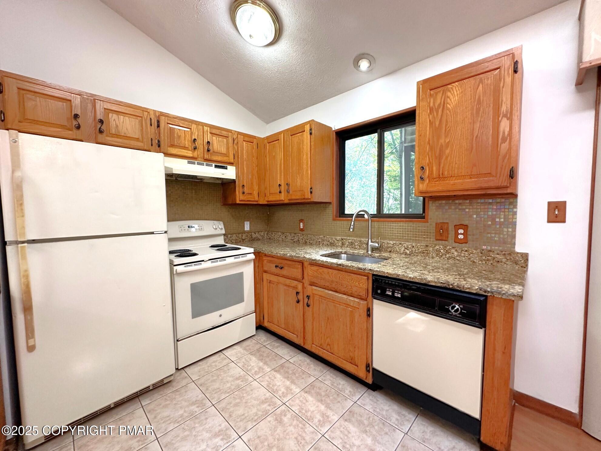 344 Pocono Boulevard, Unit 344 Bushkill, PA 18324 - Photo 6 of 20 a kitchen with granite countertop cabinets stainless steel appliances and a sink
