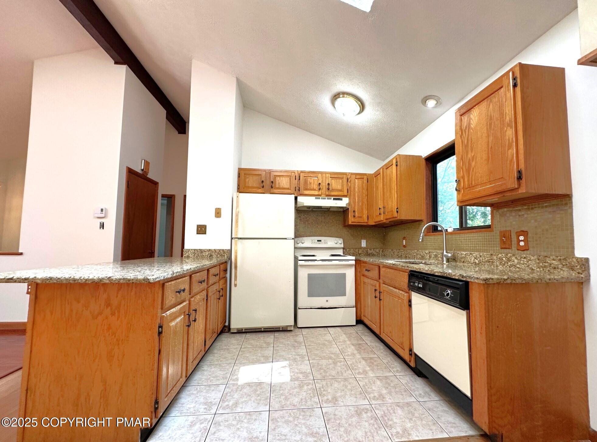 344 Pocono Boulevard, Unit 344 Bushkill, PA 18324 - Photo 7 of 20 a kitchen with a sink stove and refrigerator