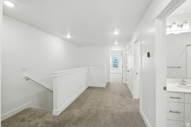 1221 West 1870 South Logan, UT 84321 - Photo 6 of 20 Upper-level hallway featuring neutral carpeting, recessed lighting, white walls, and a white railing