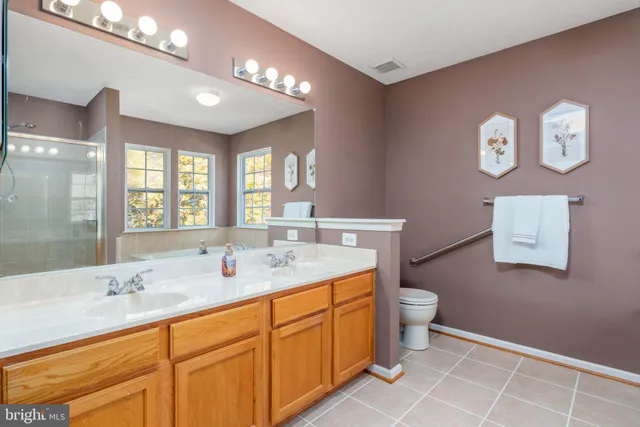 a bathroom with a double vanity sink and a mirror