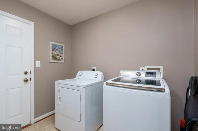 a view of storage and utility room with washer and dryer