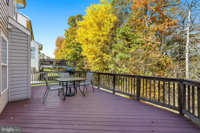 a view of a deck with table and chairs and wooden floor