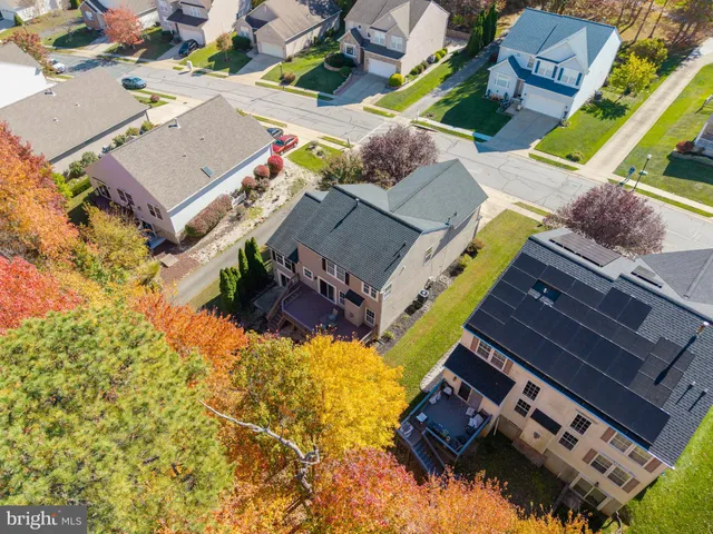 a view of residential house and tree with wooden fence