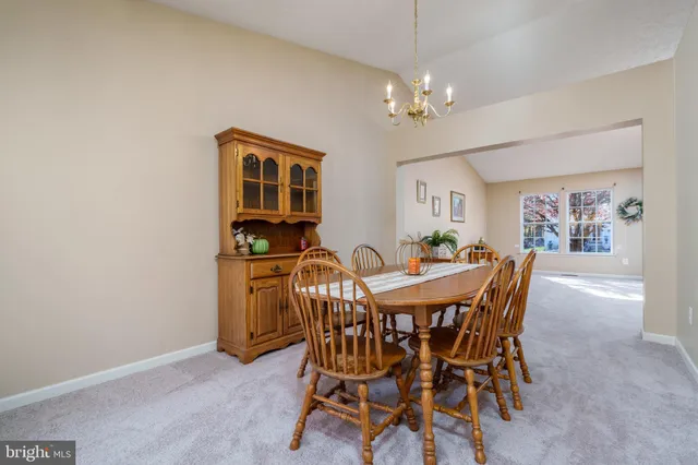 a view of a dining room with furniture and chandelier