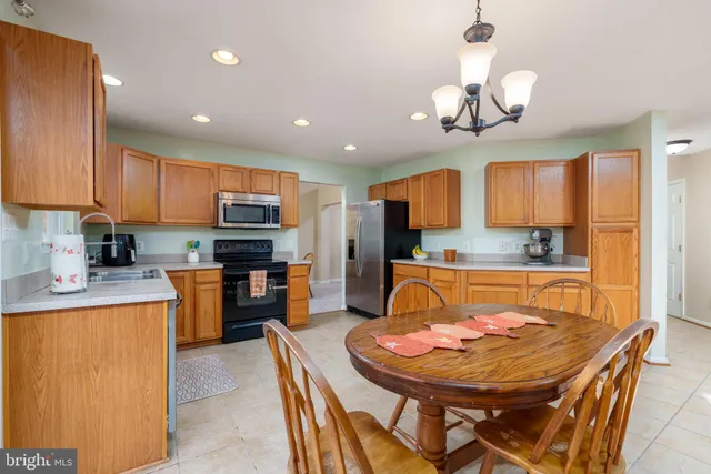 a kitchen with a dining table and chairs