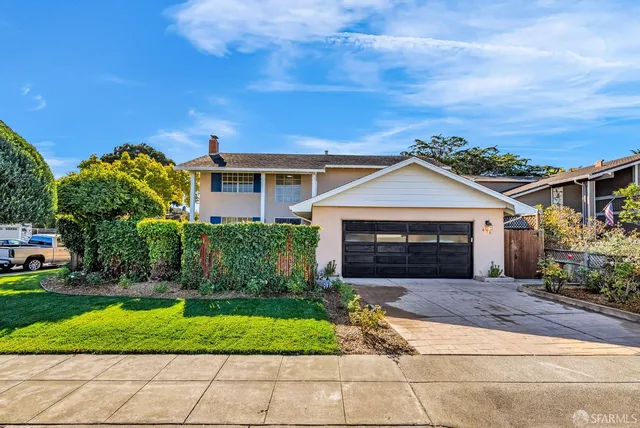 a front view of a house with a garden