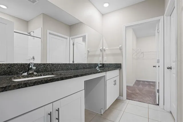 an empty room with a window and a ceiling fan