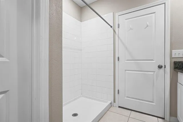 an empty room with closet and a chandelier fan