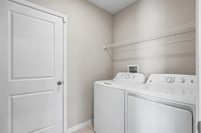 an empty room with a window and a ceiling fan