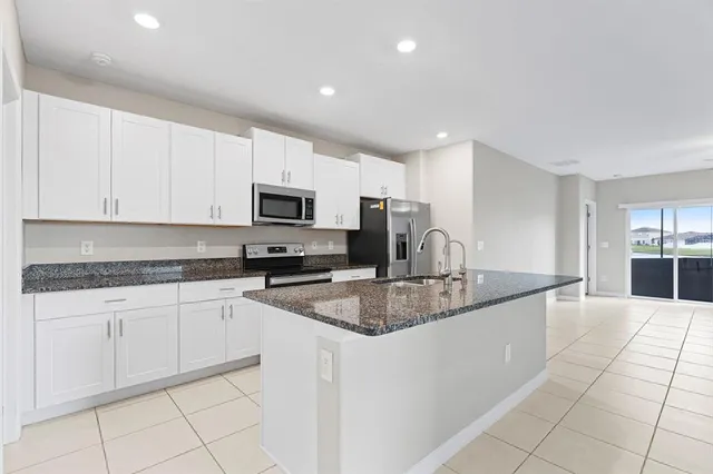 a spacious bedroom with a bed and a window