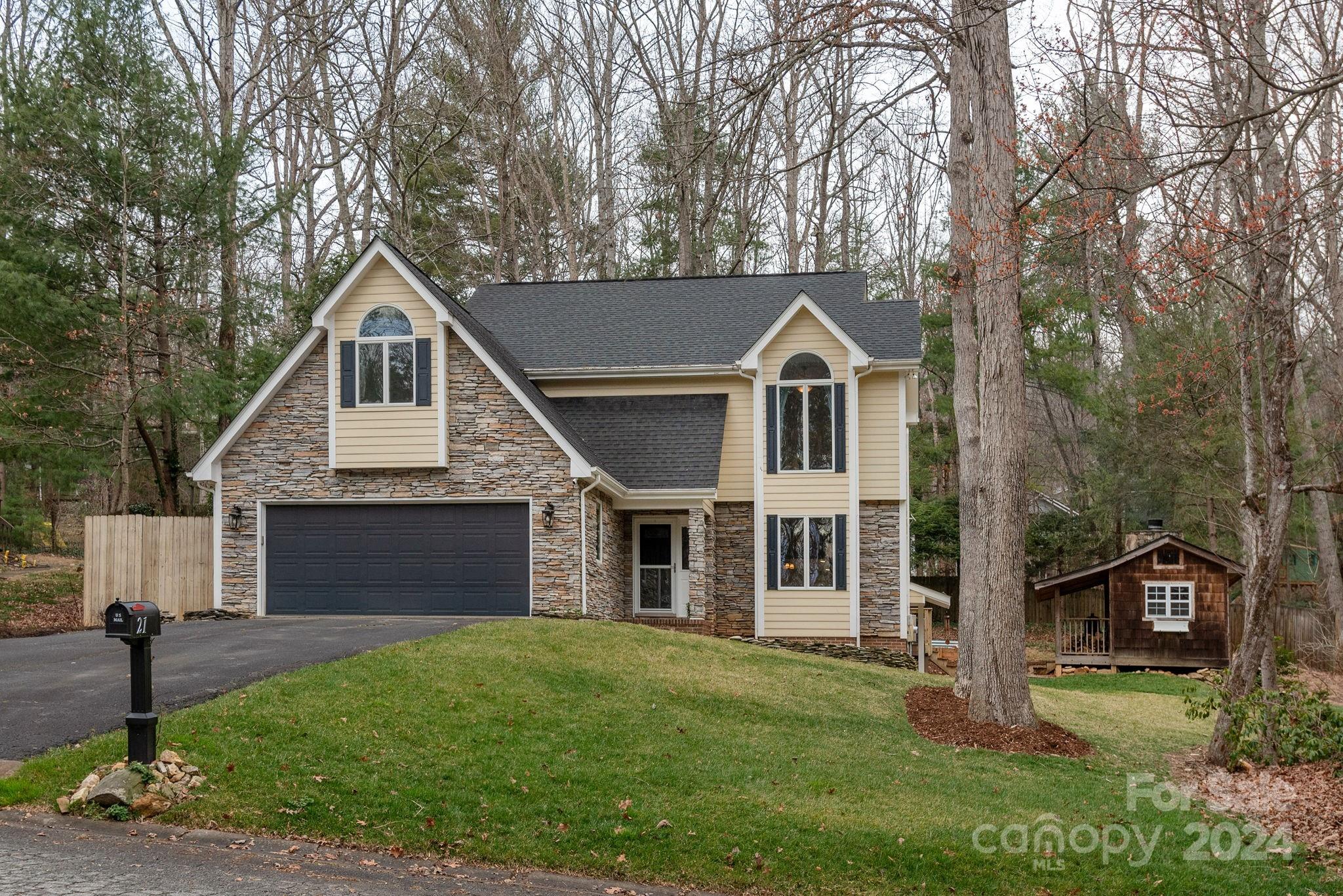 21 Spring Cove Court Arden, NC 28704 - Photo 1 of 32 a front view of a house with a yard and garage