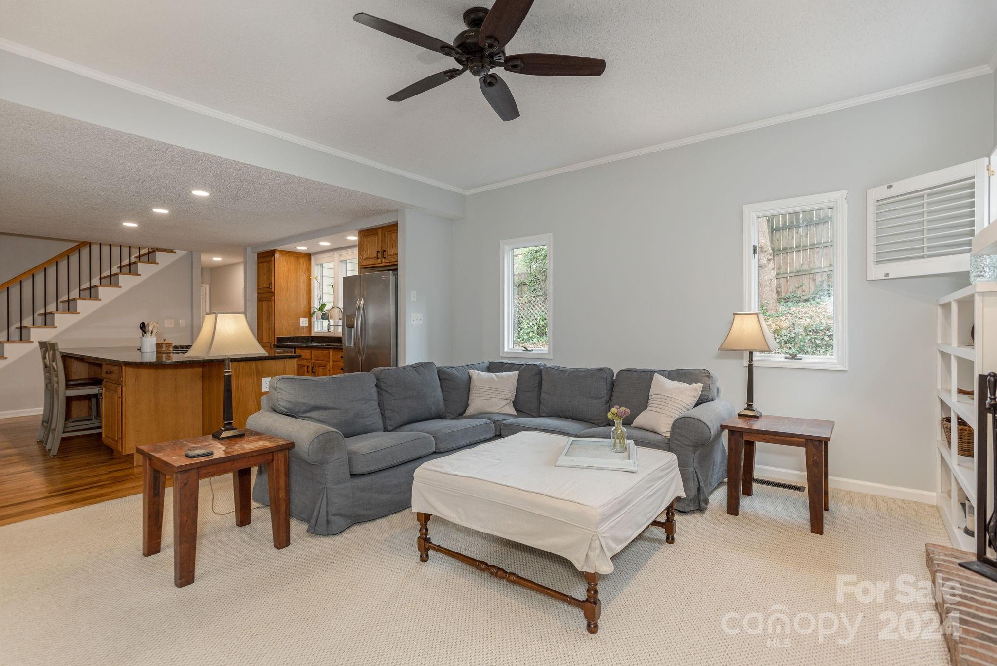 21 Spring Cove Court Arden, NC 28704 - Photo 12 of 32 a living room with furniture and a chandelier