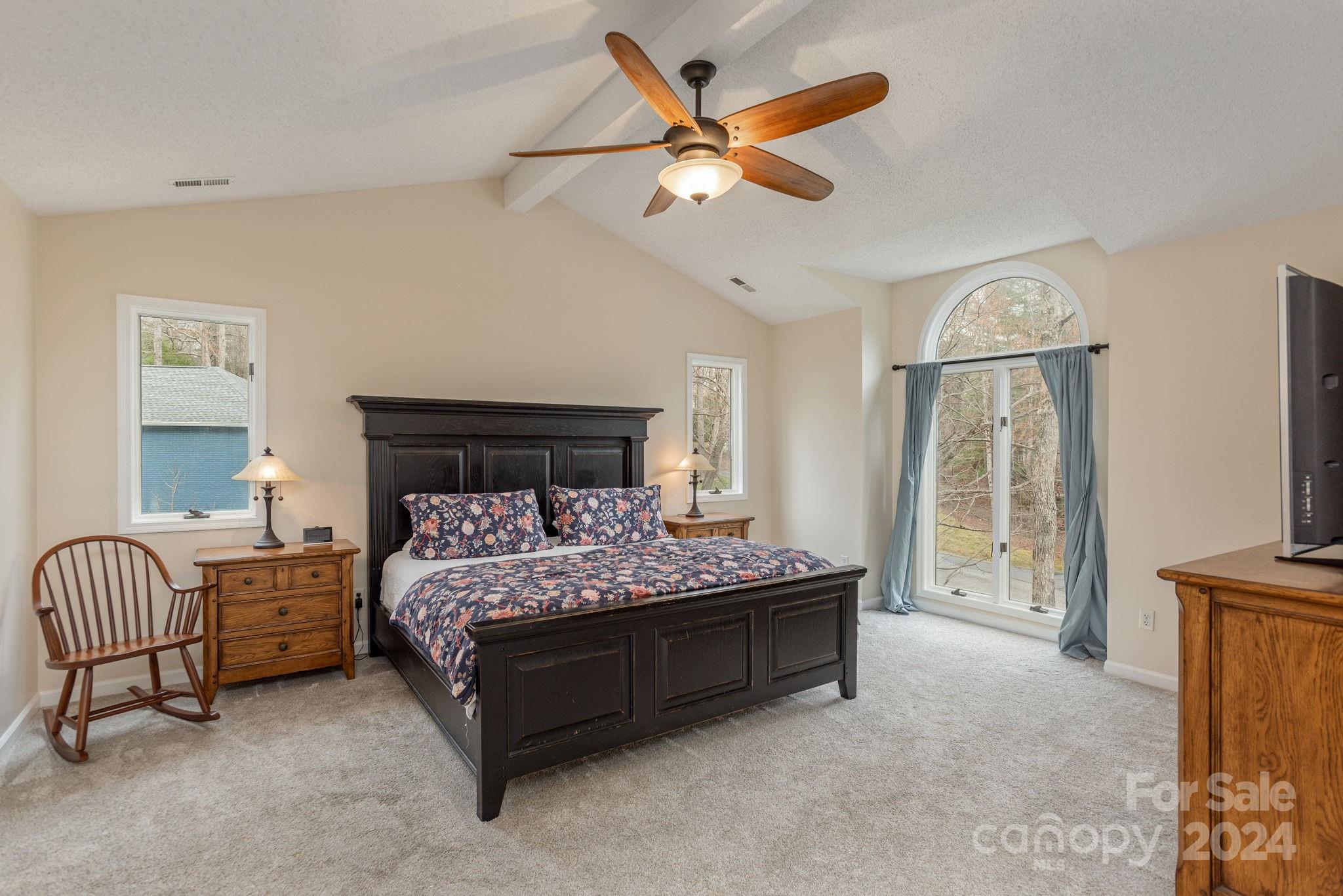 21 Spring Cove Court Arden, NC 28704 - Photo 17 of 32 a bedroom with a bed and a chandelier