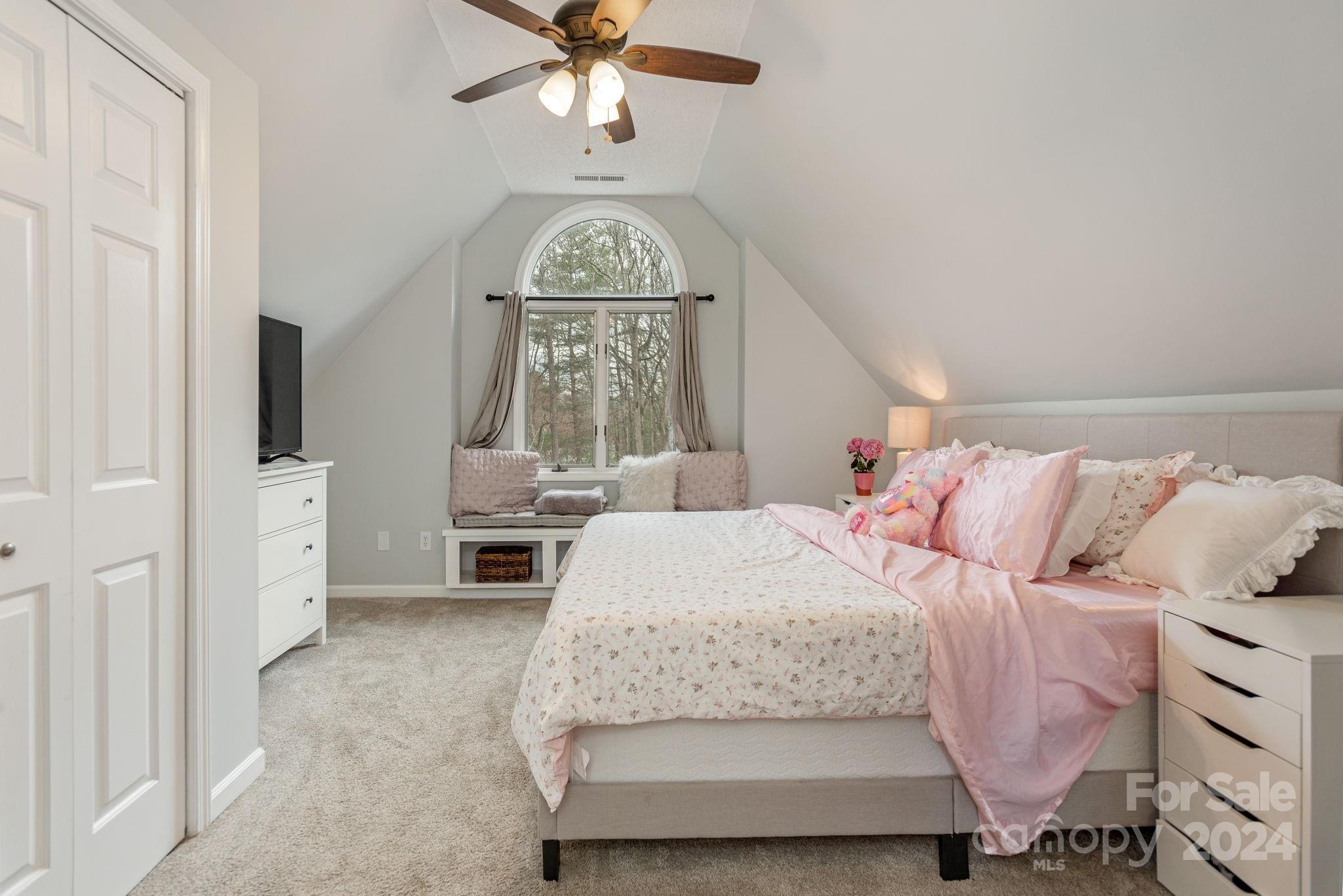 21 Spring Cove Court Arden, NC 28704 - Photo 21 of 32 a bedroom with a bed and a chandelier