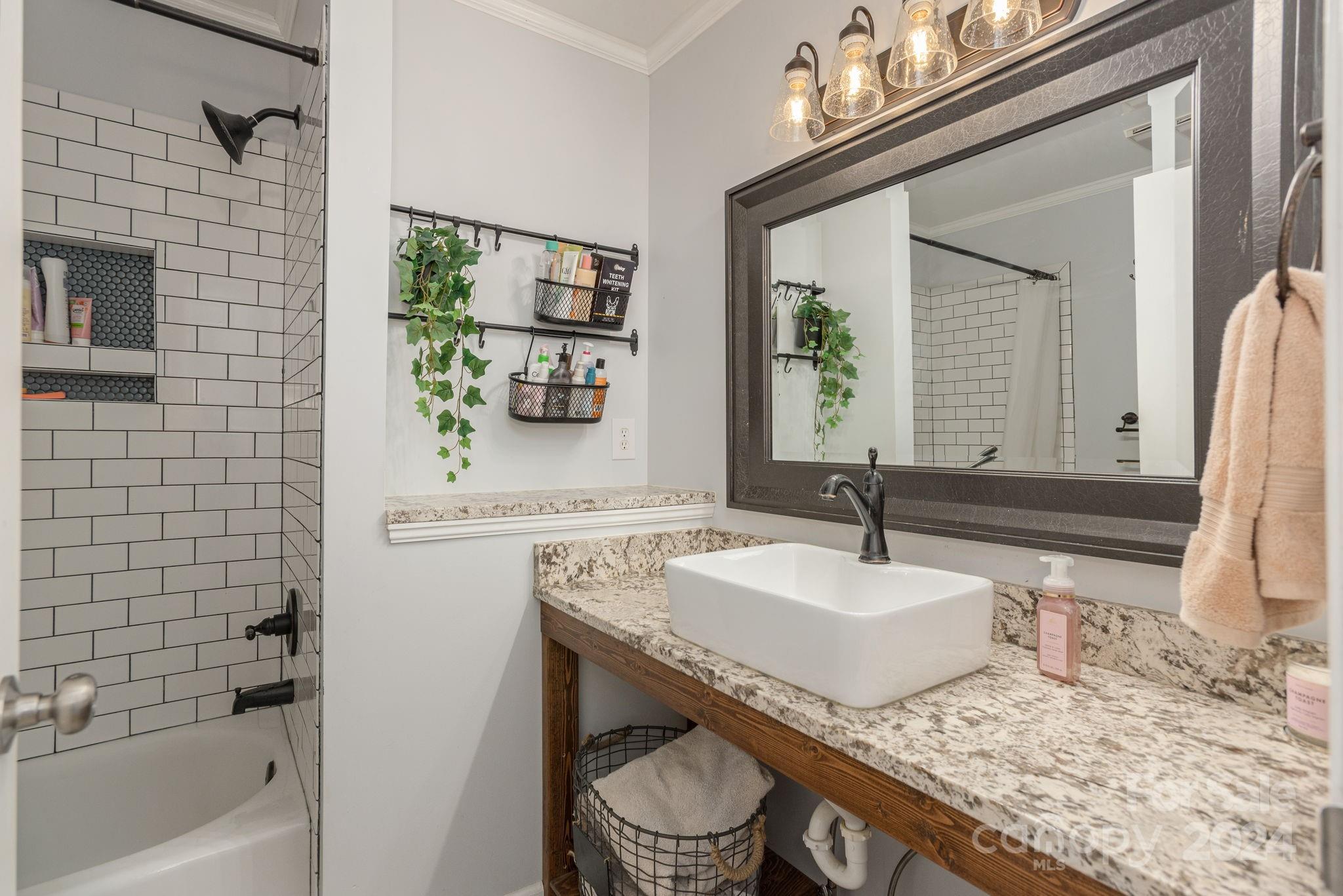 21 Spring Cove Court Arden, NC 28704 - Photo 22 of 32 a bathroom with a granite countertop sink and a mirror