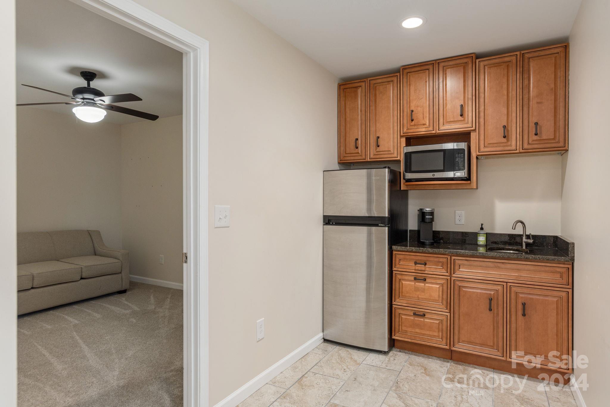 21 Spring Cove Court Arden, NC 28704 - Photo 27 of 32 a kitchen with stainless steel appliances granite countertop a refrigerator a stove a sink and dishwasher
