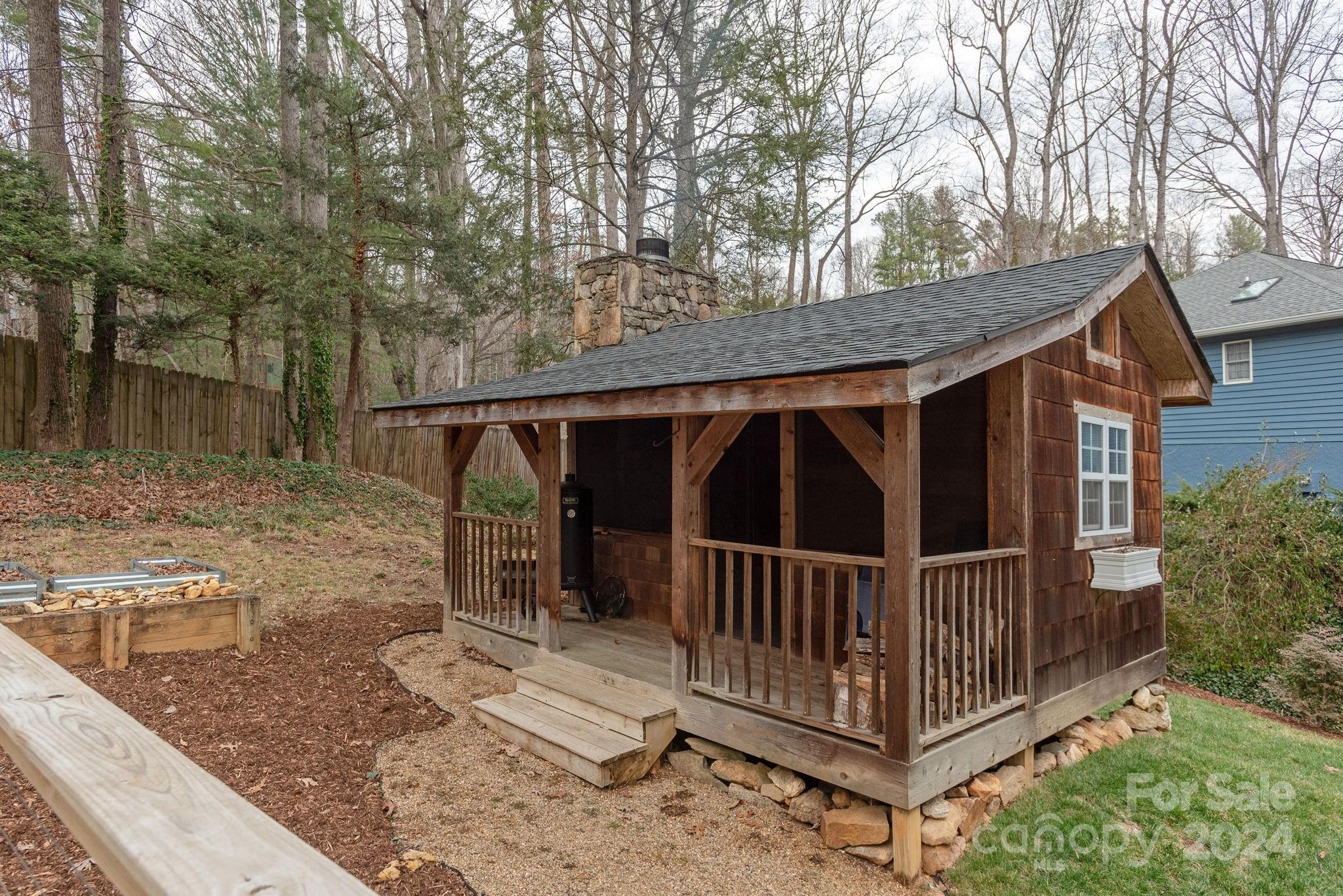 21 Spring Cove Court Arden, NC 28704 - Photo 31 of 32 a view of a small house with wooden deck front door