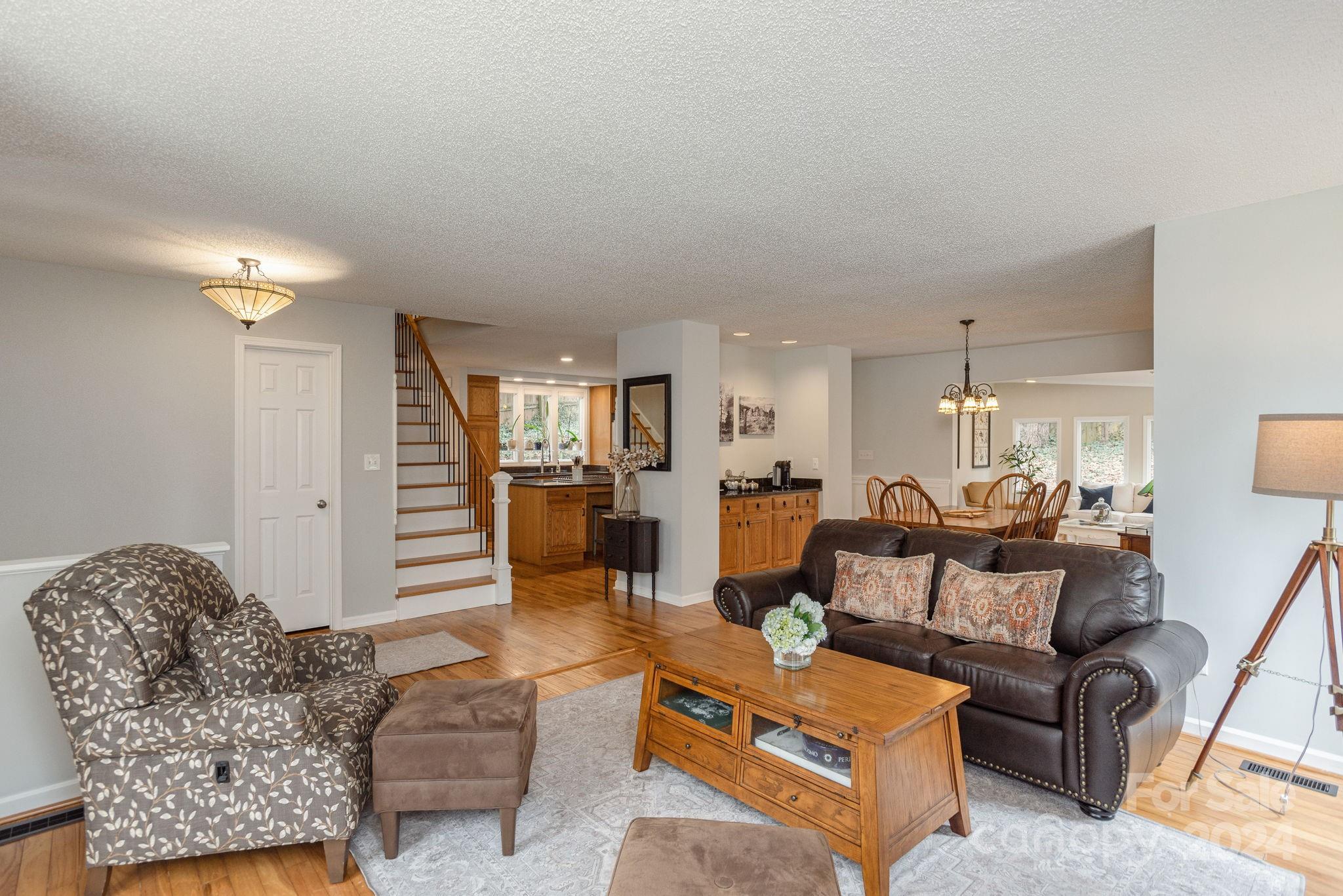 21 Spring Cove Court Arden, NC 28704 - Photo 5 of 32 a living room with furniture and a wooden floor