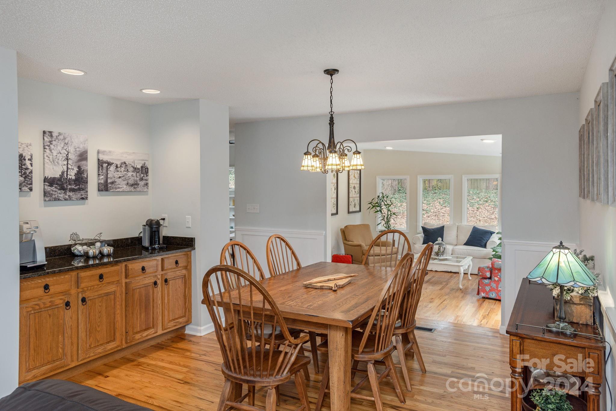 21 Spring Cove Court Arden, NC 28704 - Photo 7 of 32 a view of a dining room with furniture wooden floor and chandelier