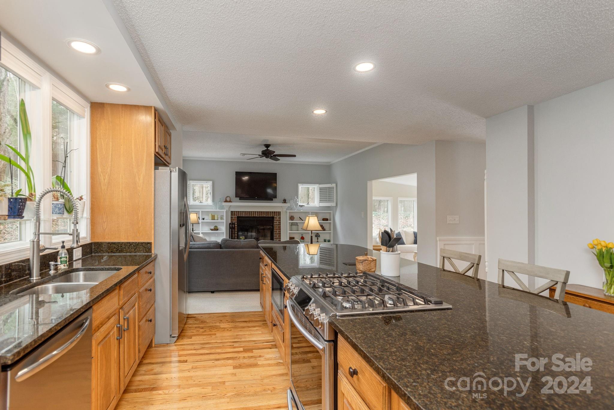 21 Spring Cove Court Arden, NC 28704 - Photo 10 of 32 a kitchen with stainless steel appliances granite countertop a sink stove and refrigerator
