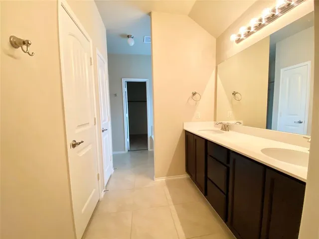 a bathroom with a double vanity sink and mirror