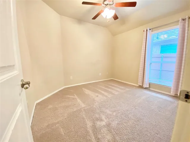 an empty room with closet and chandelier fan