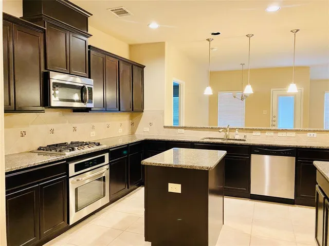 a kitchen with a sink stove and microwave