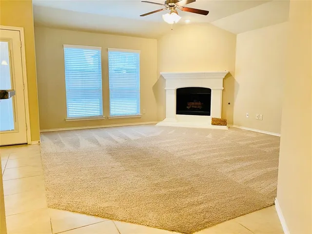 a view of an empty room with a fireplace