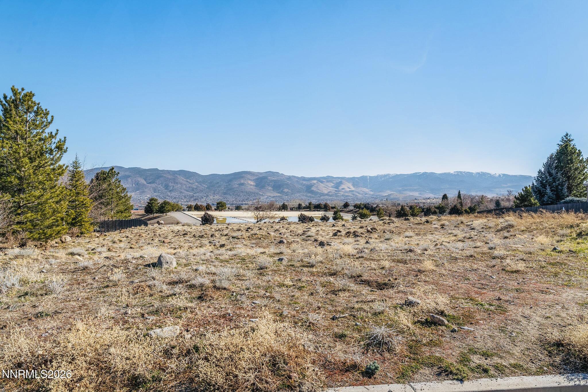 1235 Springer Court Reno, NV 89511 - Photo 3 of 9 a view of a dry yard with mountains in the background