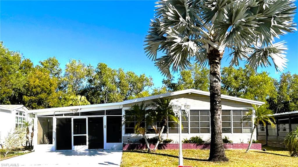 281 Ocean Reef Lane Naples, FL 34114 - Photo 20 of 30 a view of a house with a backyard and a patio
