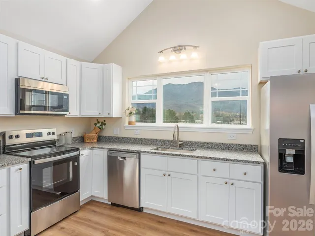 a living room with furniture and kitchen view