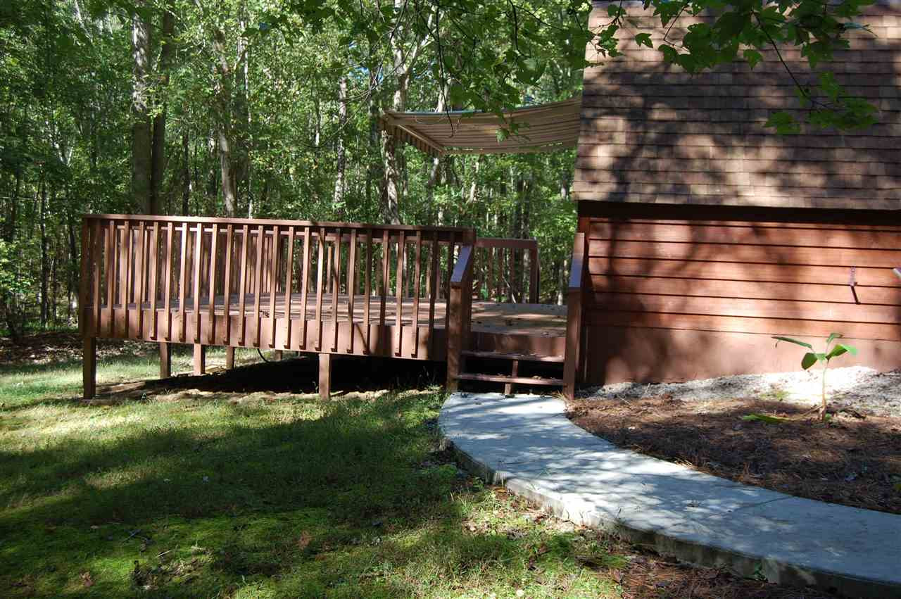 1121 Batchelor Road Apex, NC 27523 - Photo 9 of 30 Walk from side patio/garage/hot tub area to back deck off Dining room. The awning can be partially opened to allow for sun and shade if desired! Back Deck