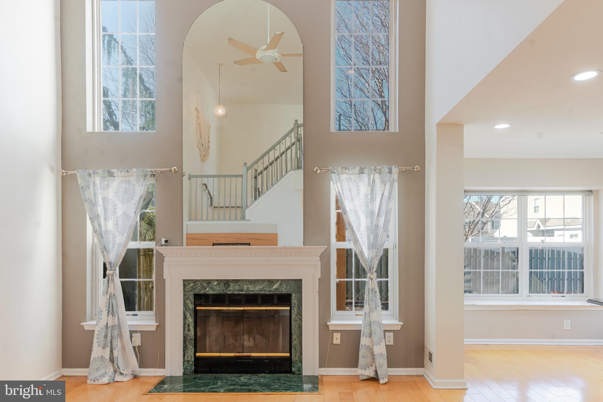 21 Stokes Road Mount Laurel, NJ 08054 - Photo 18 of 36 a living room with a fireplace and a floor to ceiling window