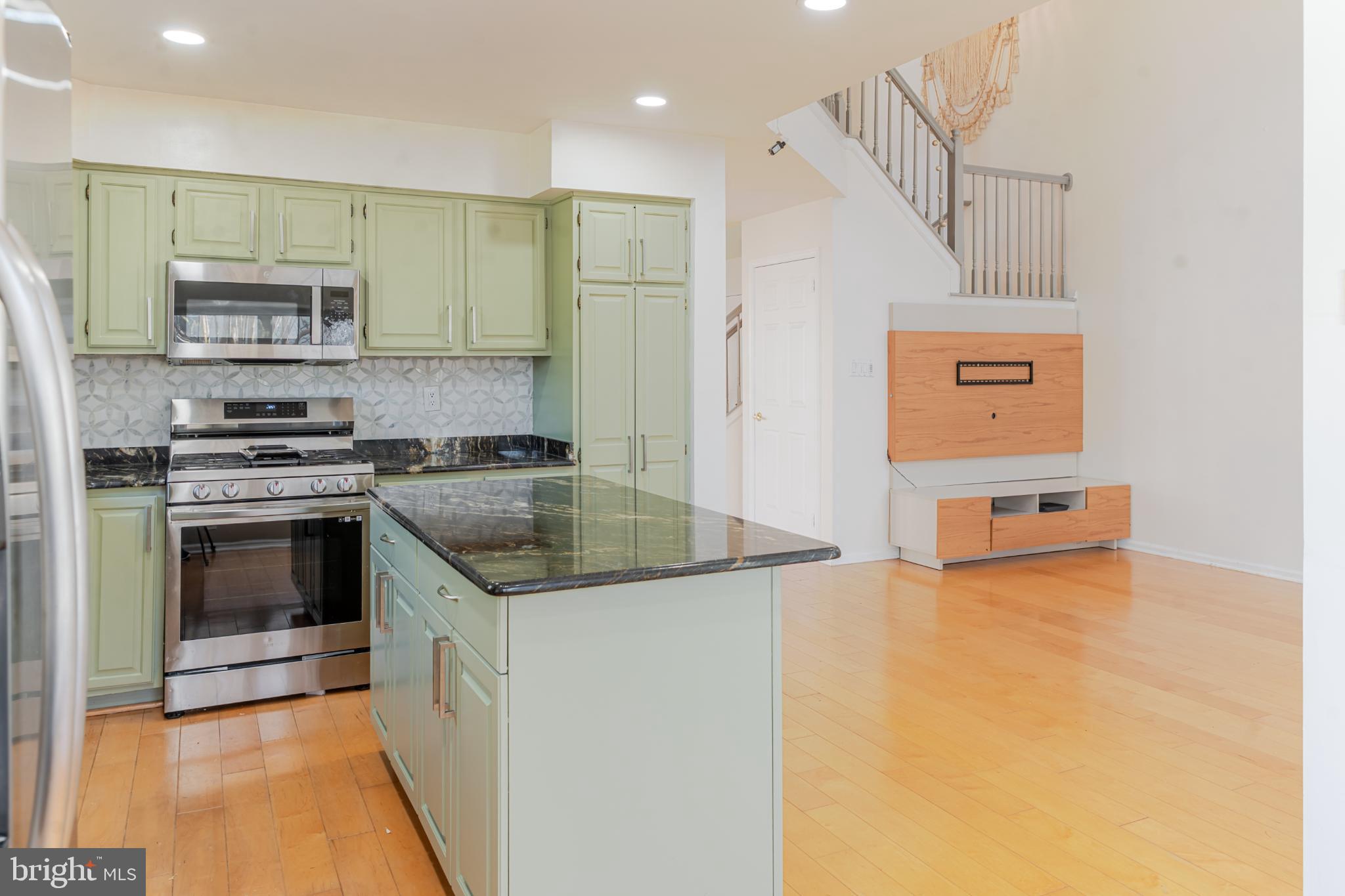 21 Stokes Road Mount Laurel, NJ 08054 - Photo 21 of 36 a kitchen with stainless steel appliances granite countertop a stove a sink and a microwave