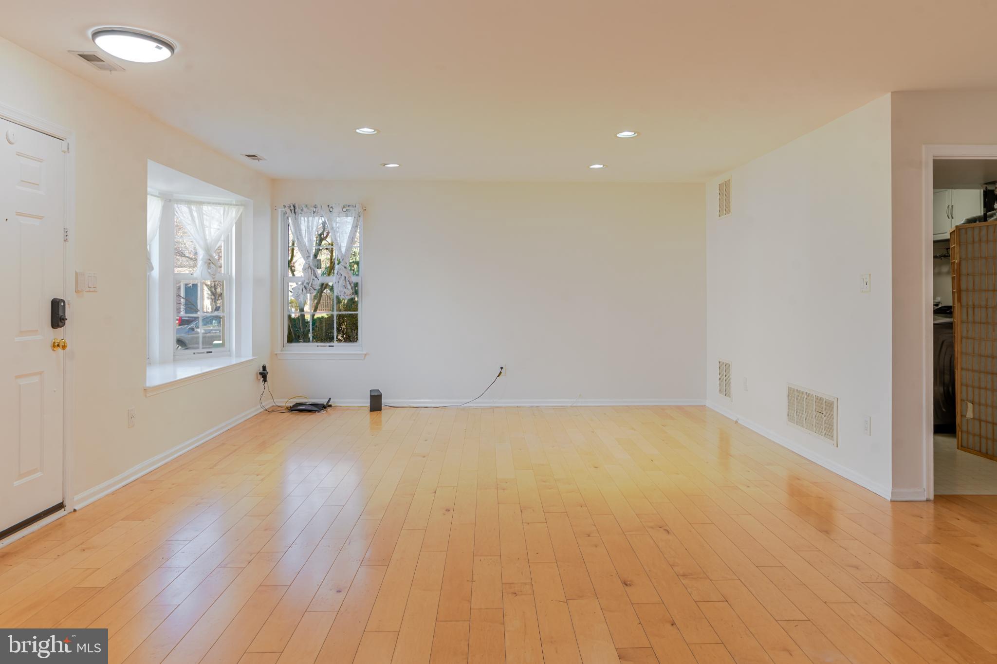 21 Stokes Road Mount Laurel, NJ 08054 - Photo 5 of 36 a view of an empty room with a window and wooden floor