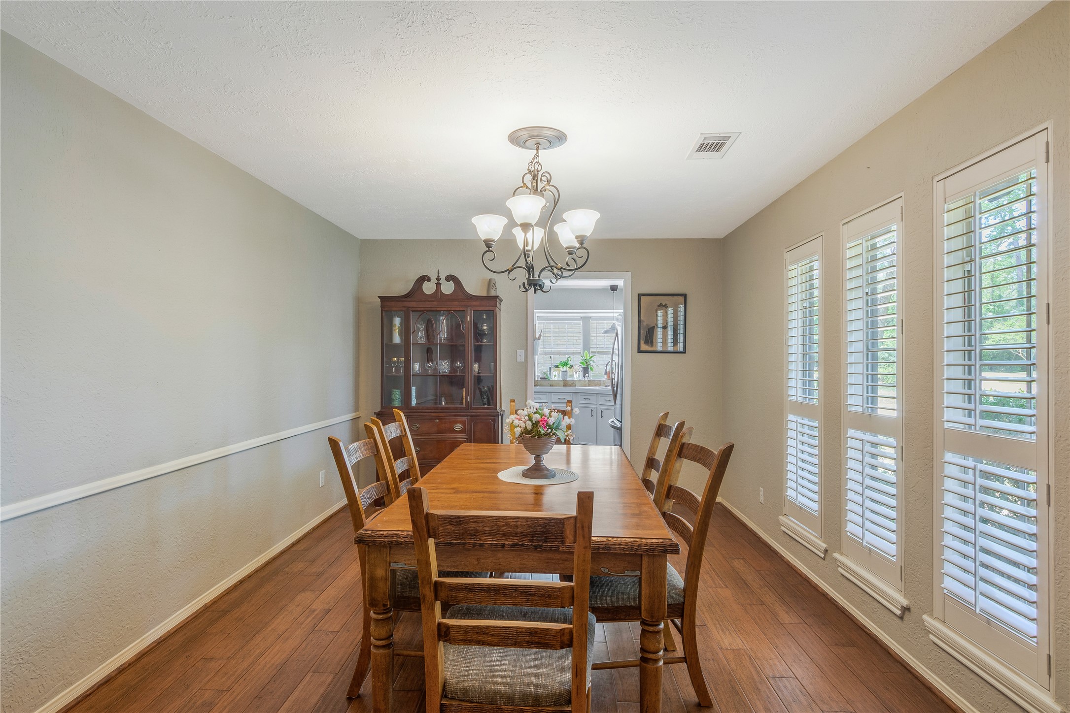 6411 Northway Drive Spring, TX 77389 - Photo 11 of 39 a dining room with furniture a chandelier and wooden floor