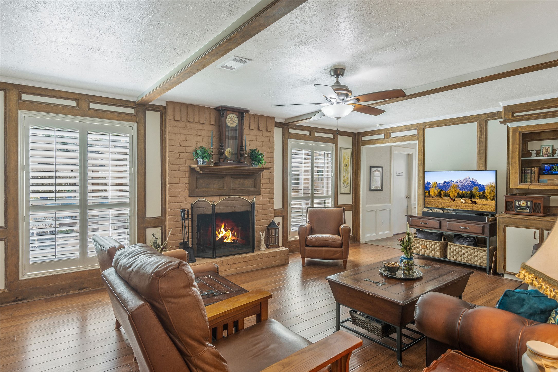 6411 Northway Drive Spring, TX 77389 - Photo 19 of 39 a living room with furniture a fireplace and a flat screen tv