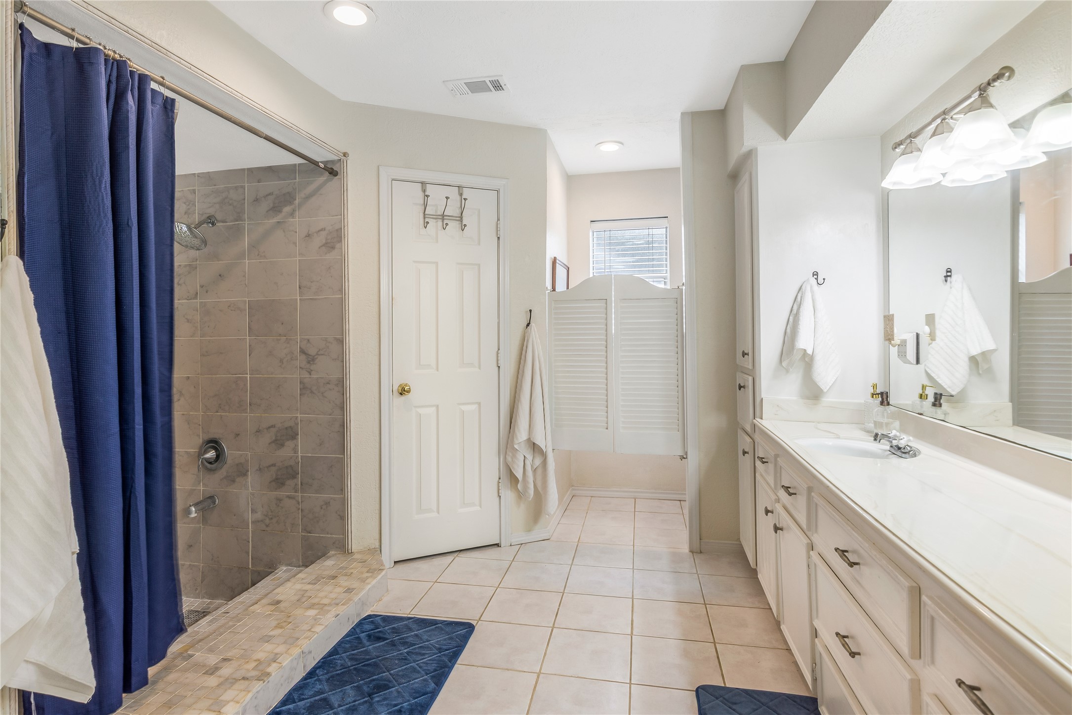 6411 Northway Drive Spring, TX 77389 - Photo 28 of 39 a spacious bathroom with a shower sink and mirror