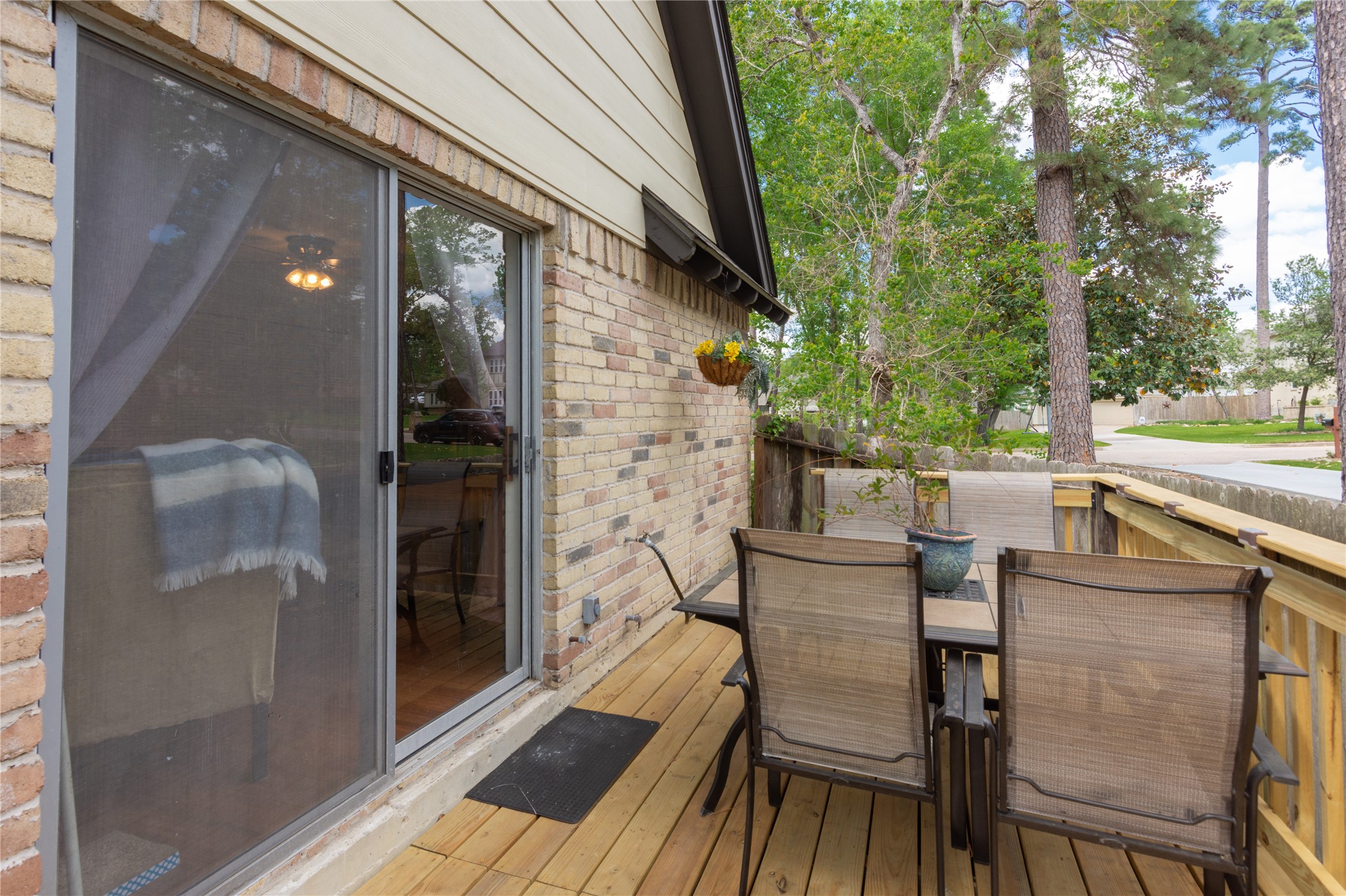 6411 Northway Drive Spring, TX 77389 - Photo 30 of 39 a view of a patio with table and chairs with wooden floor and fence