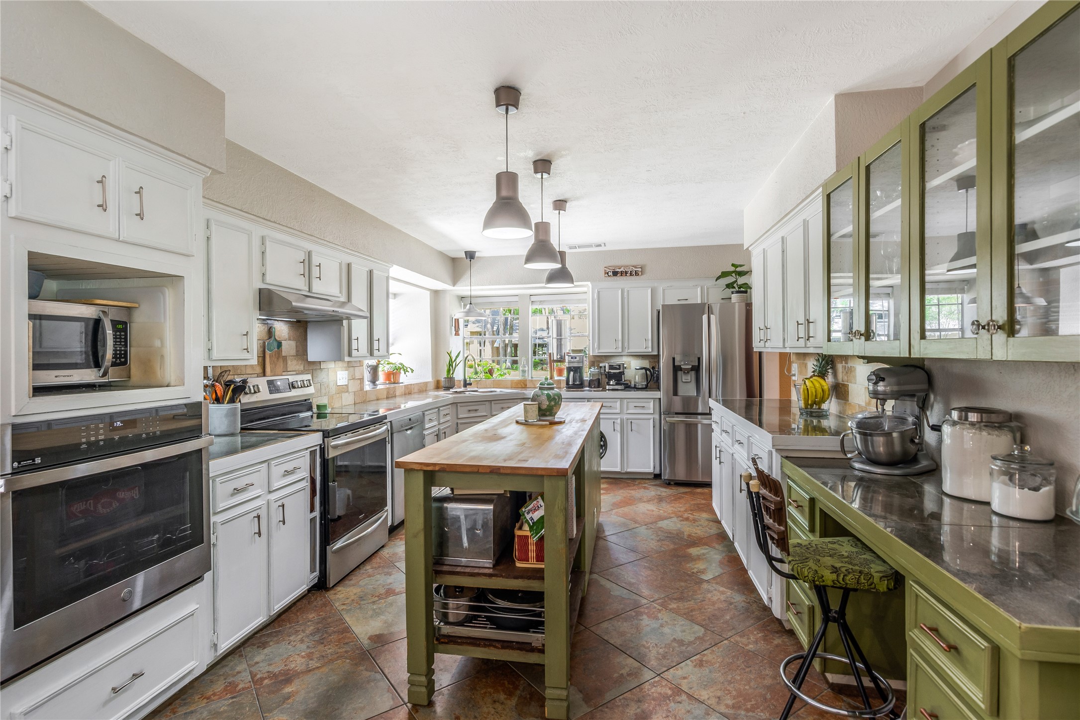 6411 Northway Drive Spring, TX 77389 - Photo 3 of 39 This spacious, open concept kitchen is a cook's delight, featuring both a built-in wall oven and a freestanding range for maximum cooking flexibility. Whether baking, roasting or preparing multiple dishes at once, the dual oven set up makes entertaining or family meals effortless.