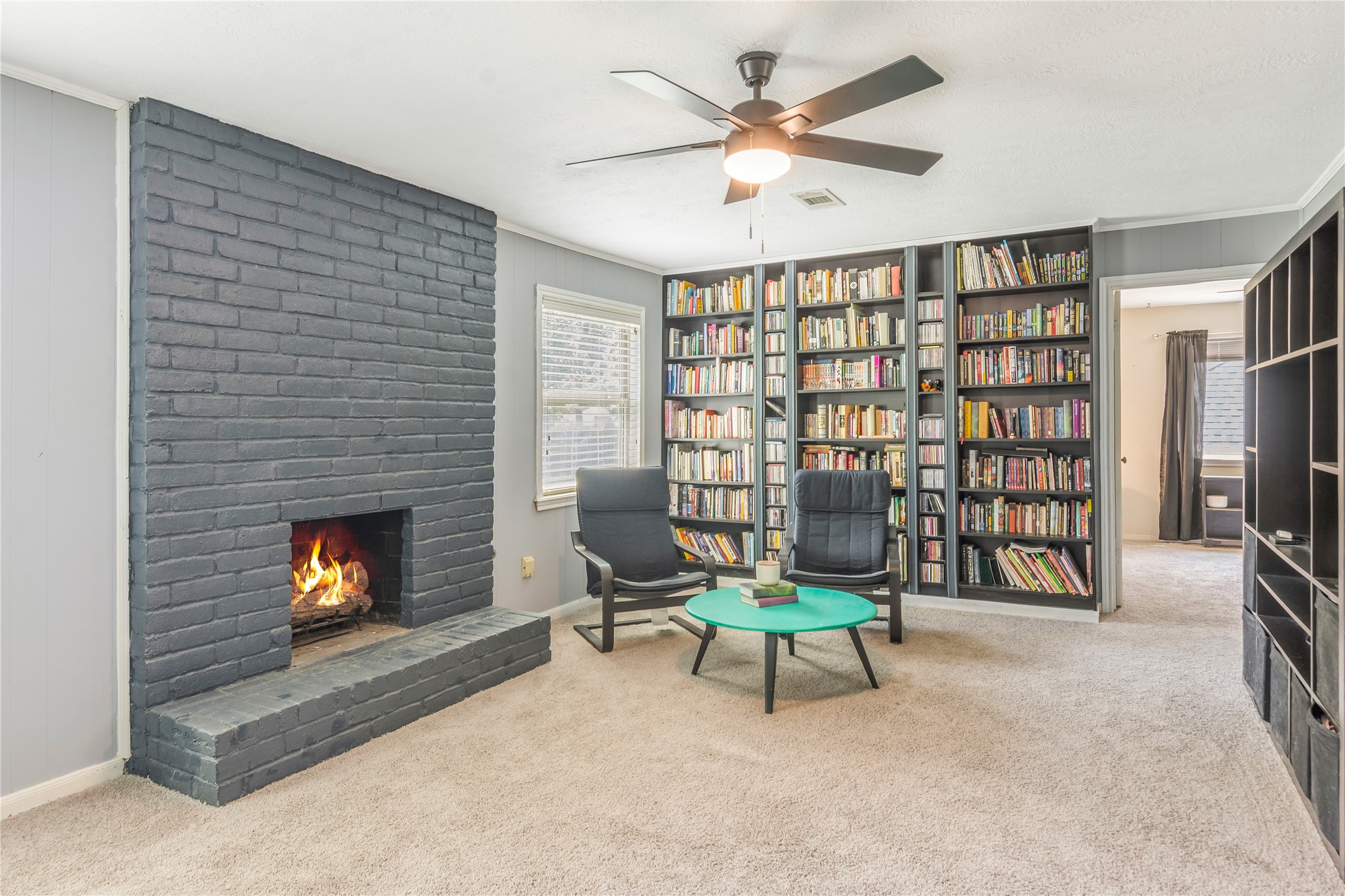 6411 Northway Drive Spring, TX 77389 - Photo 31 of 39 Versatile game room featuring a massive custom bookshelf wall and a cozy gas log fireplace. Perfect for quiet reading or entertaining friends, complete with brand new carpet!