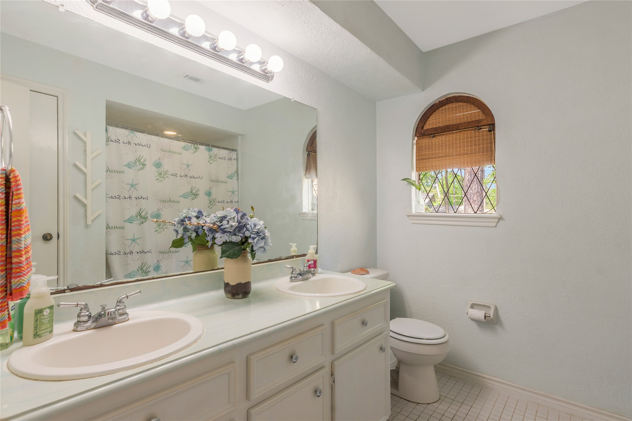 6411 Northway Drive Spring, TX 77389 - Photo 35 of 39 a bathroom with a granite countertop toilet a sink and mirror