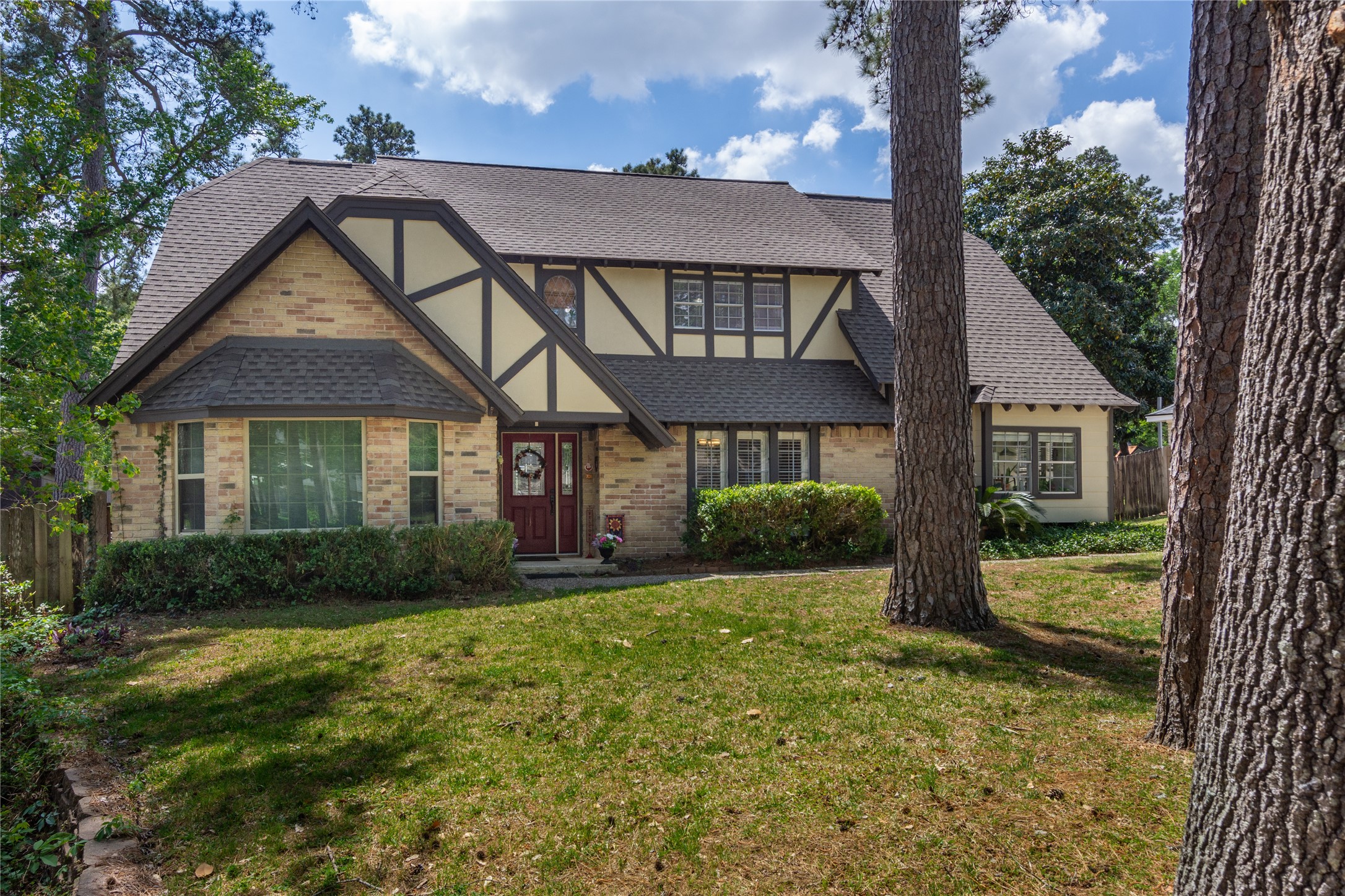 6411 Northway Drive Spring, TX 77389 - Photo 6 of 39 a view of a brick house with a yard and large trees