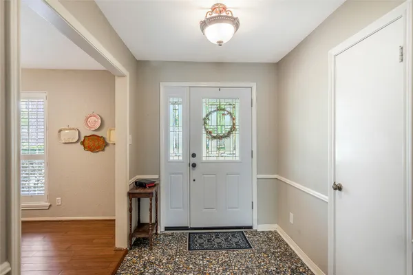 a dining room with furniture a chandelier and wooden floor