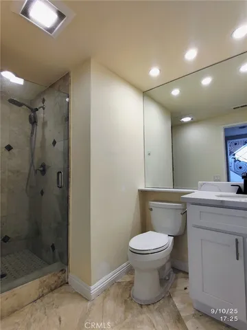a bathroom with a toilet sink and shower